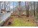 Spacious backyard with a white fence, lush green lawn and mature trees at 140 Melbourne Dr, Fort Mill, SC 29708