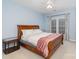 Bright bedroom features a wood sleigh bed, ceiling fan, and natural light at 140 Melbourne Dr, Fort Mill, SC 29708