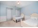 Cozy bedroom with two twin beds, chair rail, and blue accent walls at 140 Melbourne Dr, Fort Mill, SC 29708