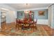 Formal dining room featuring elegant chandelier, wainscoting, and a large wooden table at 140 Melbourne Dr, Fort Mill, SC 29708