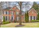 Elegant brick home with black shutters, arched entry, and well-maintained landscaping at 140 Melbourne Dr, Fort Mill, SC 29708
