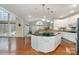 Bright kitchen features white cabinets, granite countertops, a center island, and breakfast nook at 140 Melbourne Dr, Fort Mill, SC 29708
