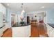 Open-concept kitchen with granite countertops and stainless steel appliances flows into the bright living area at 140 Melbourne Dr, Fort Mill, SC 29708