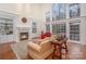 Bright living room features a fireplace, built-in shelving, and large windows overlooking the yard at 140 Melbourne Dr, Fort Mill, SC 29708