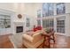Bright living room features a fireplace, built-in shelving, and large windows overlooking the yard at 140 Melbourne Dr, Fort Mill, SC 29708
