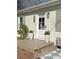 Charming front door with decorative plants on the wooden porch with steps and the house number on the side at 1420 Columbus St, Albemarle, NC 28001