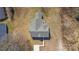 Overhead view of a house with gray roof, surrounded by a dry, grassy lawn and trees at 1507 W Davidson Ave, Gastonia, NC 28052