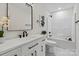 Clean bathroom featuring a modern vanity, white tiling, and a bathtub at 1507 W Davidson Ave, Gastonia, NC 28052