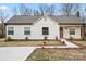 Beautiful single-story home with a well manicured lawn and walkway to the covered porch at 1507 W Davidson Ave, Gastonia, NC 28052