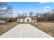Charming single-story home with a well-manicured lawn and a long concrete driveway at 1507 W Davidson Ave, Gastonia, NC 28052