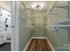 Bright walk-in closet featuring custom shelving, wood-look flooring, and modern lighting at 1507 W Davidson Ave, Gastonia, NC 28052
