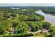 Scenic aerial view of a lakeside community with homes nestled among lush green trees and tranquil waterways at 1547 Sunset Pointe Dr, Salisbury, NC 28146