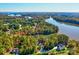 Expansive aerial view of a lakeside property showcasing a house surrounded by trees, with lake access at 1547 Sunset Pointe Dr, Salisbury, NC 28146