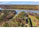 Aerial view of wooded land with a home located near a calm body of water at 1547 Sunset Pointe Dr, Salisbury, NC 28146
