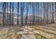 Landscaped backyard path, creating a serene and inviting outdoor space surrounded by trees at 1547 Sunset Pointe Dr, Salisbury, NC 28146