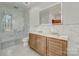 Modern bathroom features double vanity, frameless shower, and herringbone tile floors at 1547 Sunset Pointe Dr, Salisbury, NC 28146