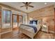 Bedroom features wood-paneled walls, ceiling fan and a door to the outdoors, bringing nature indoors at 1547 Sunset Pointe Dr, Salisbury, NC 28146