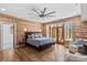 Inviting bedroom showcasing wood walls, hardwood floors, a king-size bed, and French doors leading to a patio at 1547 Sunset Pointe Dr, Salisbury, NC 28146