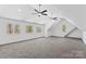 Spacious bonus room with carpeted floors, multiple windows, and vaulted ceilings, perfect for entertaining at 1547 Sunset Pointe Dr, Salisbury, NC 28146