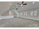 Spacious bonus room bathed in natural light with neutral carpet, ideal for recreation and relaxation at 1547 Sunset Pointe Dr, Salisbury, NC 28146