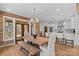 Dining room view with wood table, bench, and kitchen with white cabinets at 1547 Sunset Pointe Dr, Salisbury, NC 28146