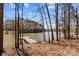 Lake view featuring a private dock surrounded by trees and a glimpse of the waterfront at 1547 Sunset Pointe Dr, Salisbury, NC 28146
