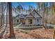 Stunning exterior view of a stone and gray home with a walkway and landscaping at 1547 Sunset Pointe Dr, Salisbury, NC 28146