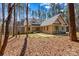 Two story stone and siding home with a walkway leading to the entry and surrounded by mature trees at 1547 Sunset Pointe Dr, Salisbury, NC 28146