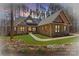 Charming stone and siding home with manicured lawn and inviting walkway to a double door entry at 1547 Sunset Pointe Dr, Salisbury, NC 28146