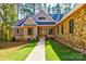 Inviting stone and siding home with well-maintained landscaping and a stone walkway leading to the front door at 1547 Sunset Pointe Dr, Salisbury, NC 28146