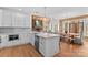 Open-concept kitchen with stainless steel appliances, island seating, and natural wood accents at 1547 Sunset Pointe Dr, Salisbury, NC 28146
