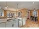 Open kitchen with wood accents, stainless appliances, and marble countertops open to breakfast nook at 1547 Sunset Pointe Dr, Salisbury, NC 28146