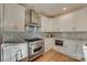 Gourmet kitchen showcasing stainless steel appliances, tiled backsplash, and marble countertops at 1547 Sunset Pointe Dr, Salisbury, NC 28146