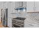 Modern kitchen features stainless steel appliances, custom tile backsplash, and marble countertops at 1547 Sunset Pointe Dr, Salisbury, NC 28146