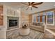 Cozy living room features a stone fireplace, wood accent wall, and a double door at 1547 Sunset Pointe Dr, Salisbury, NC 28146