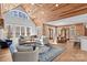 Spacious living room with vaulted wood ceiling, large windows, and hardwood floors at 1547 Sunset Pointe Dr, Salisbury, NC 28146