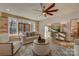Sun-filled living room boasts wood accents, comfortable seating, and double door access at 1547 Sunset Pointe Dr, Salisbury, NC 28146