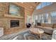 Cozy living room boasts a stone fireplace and large windows at 1547 Sunset Pointe Dr, Salisbury, NC 28146