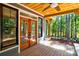 Covered patio overlooking lush greenery and wooded surroundings at 1547 Sunset Pointe Dr, Salisbury, NC 28146