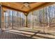 Screened-in porch with a view of the wooded area and lake, providing a relaxing outdoor space at 1547 Sunset Pointe Dr, Salisbury, NC 28146