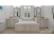 Bathroom showcasing a soaking tub, dual vanities, and stylish mirrors at 15913 Robbins Green Dr, Cornelius, NC 28031