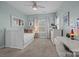 Bright bedroom with a twin bed, soft carpet, and a charming white writing desk and chair at 15913 Robbins Green Dr, Cornelius, NC 28031