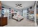 Bedroom with a ceiling fan, neutral carpet, a full-size bed, and built-in shelving and desk at 15913 Robbins Green Dr, Cornelius, NC 28031