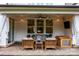 Welcoming covered patio with comfortable seating, string lights, and an outdoor entertainment area at 15913 Robbins Green Dr, Cornelius, NC 28031