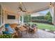 Relaxing covered patio with comfortable seating, string lights, and a ceiling fan for outdoor enjoyment at 15913 Robbins Green Dr, Cornelius, NC 28031