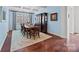 Elegant dining room with coffered ceilings, large windows, and stylish furnishings at 15913 Robbins Green Dr, Cornelius, NC 28031