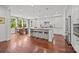 Open-concept kitchen with a large island, stainless steel appliances, and hardwood floors at 15913 Robbins Green Dr, Cornelius, NC 28031