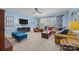 Spacious living room with blue accent walls, plush seating, a ceiling fan, and natural light at 15913 Robbins Green Dr, Cornelius, NC 28031