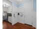 Mudroom with beadboard accent walls, coat hooks, and access to the laundry room with modern washer and dryer at 15913 Robbins Green Dr, Cornelius, NC 28031