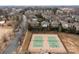 Aerial image of two tennis courts with players, surrounded by trees and neighborhood homes at 15913 Robbins Green Dr, Cornelius, NC 28031